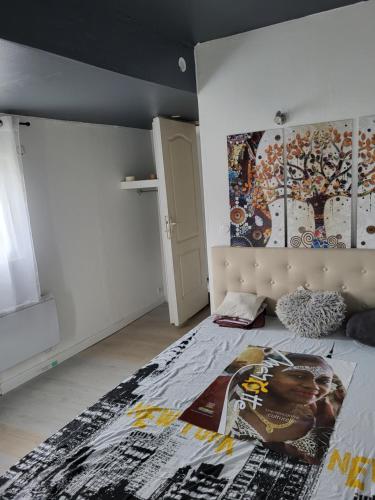 AureilhanHamidani jkkld的卧室配有一张壁挂式海报的床
