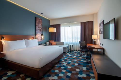 塞拉亚Doubletree By Hilton Celaya的配有一张床和一张书桌的酒店客房