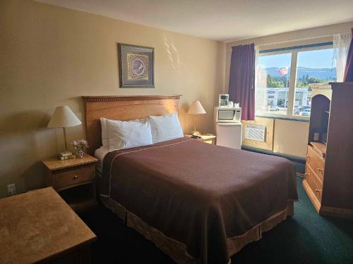 艾伯尼港Ocean Marina Hotel的一间设有大床和窗户的酒店客房