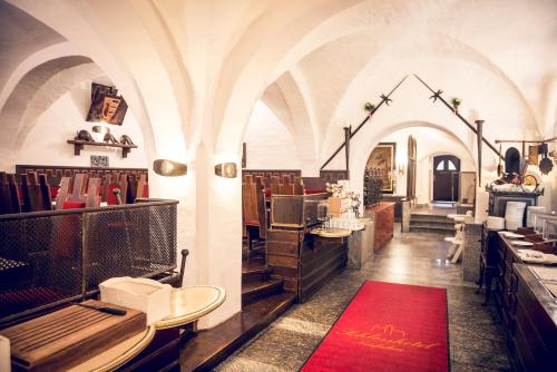 讷凡姆伊恩涅德巴Schlosshotel Neufahrn的一间红色地毯的餐厅