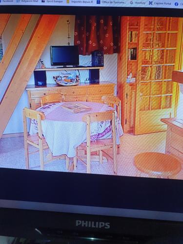 Saint-PancraceCatarmina的电视屏幕显示带桌椅的厨房