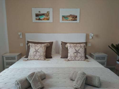 科斯塔特吉塞Bungalow Paseo del Mar- PLAYA ROCA Residence sea front access - Free AC - Wifi的卧室配有带枕头的大型白色床