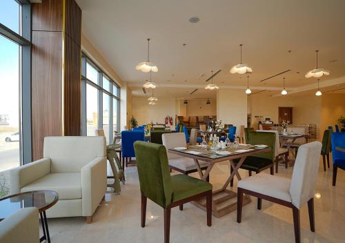 马斯喀特Kyriad Muscat Hotel的一间带桌椅的用餐室