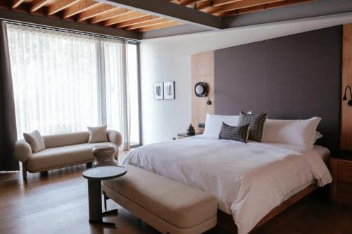 墨西哥城Colima 71 Art - Community - Hotel的卧室配有一张白色大床和一把椅子