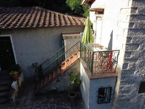 雷杰洛La Casa del Nonno - Tiny House的一个带遮阳伞和庭院的外部楼梯
