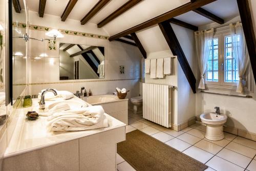 Ravelles bois de ravel chambres d'hôtes的一间带水槽、浴缸和卫生间的浴室