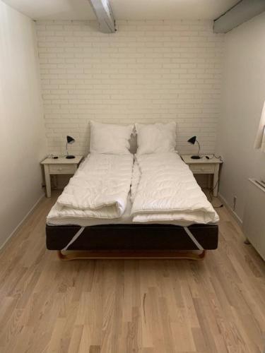 赫尔辛厄Dyrlundgård的一张大床,位于带2个床头柜的房间