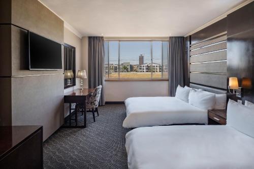卢萨卡卢萨卡塔普罗提酒店的酒店客房配有两张床和一张书桌