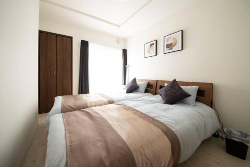 小樽Otaru SAMPO的一间卧室设有一张大床和大窗户