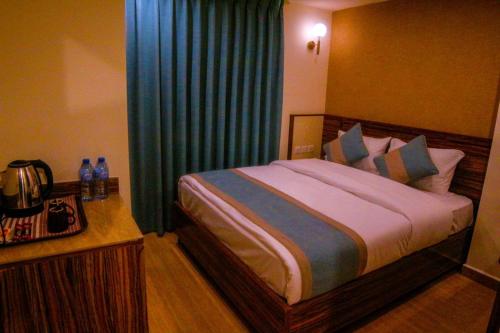 亚喀巴ِAfnan hotel的一间卧室配有一张带蓝色窗帘的大床