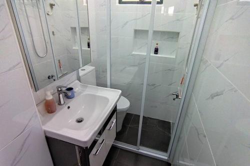 蕉赖Forest Valley Homestay Bungalow for Family/Group Staycation/Gathering的白色的浴室设有水槽和淋浴。