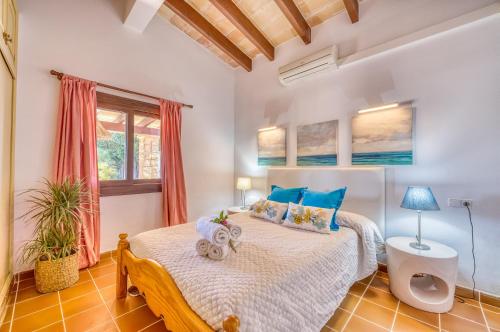 埃尔波特Ideal Property Mallorca - Rotes的一间卧室配有一张带蓝色枕头的床