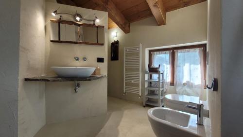 BussolenoWidy's House的一间带两个盥洗盆、卫生间和窗户的浴室