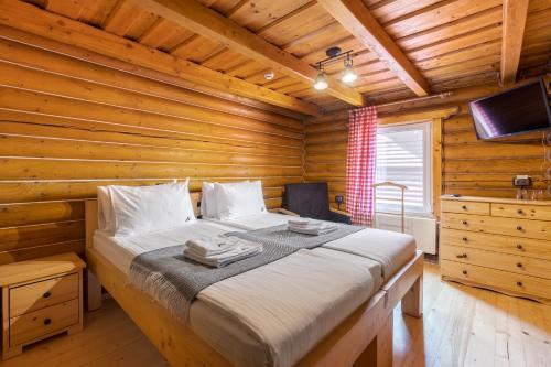 德拉格布拉特Gremi Hotel的小木屋内一间卧室,配有一张床