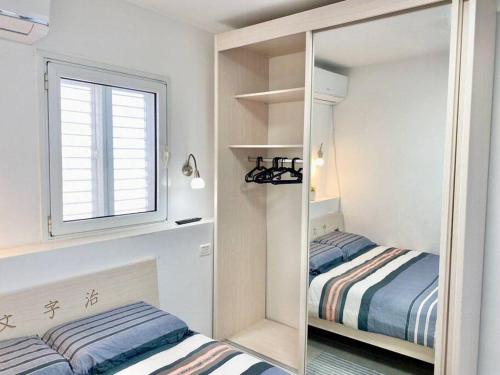 海法Seaside cozy apartment的一间小卧室,配有两张床和镜子