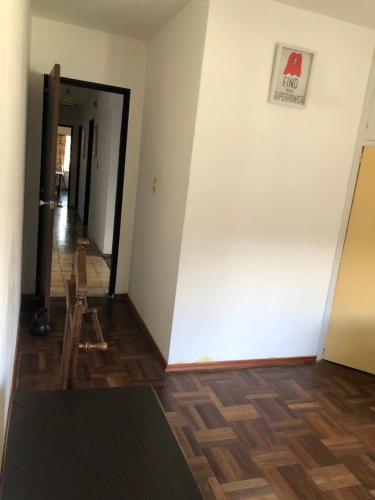 蒙得维的亚Ordeig 2223的走廊上设有白色的墙壁和木地板