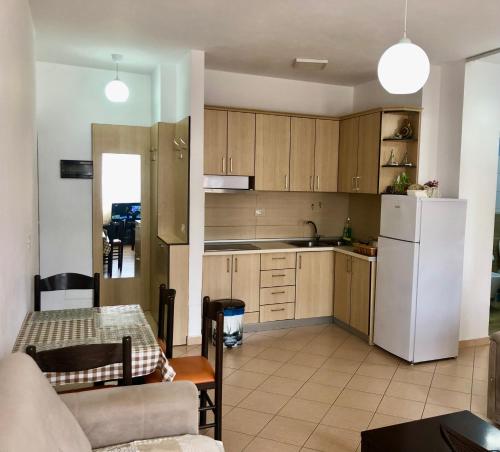 都拉斯Beach Apartments Durres的厨房配有白色冰箱和桌子