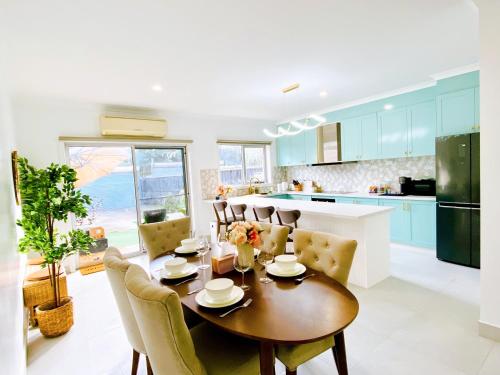 墨尔本The Daisy House - Family-friendly & top convenient location的厨房以及带桌椅的用餐室。