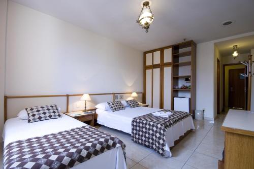 朗多尼亚皇宫酒店客房内的一张或多张床位
