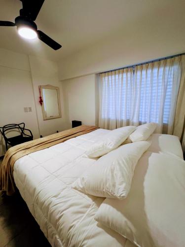 圣罗莎Departamento Catedral的卧室配有一张大白色床和窗户
