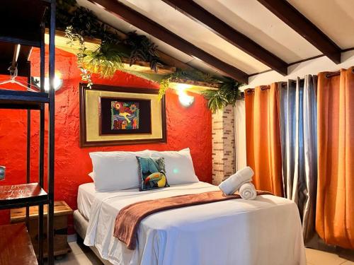 巴拿马城巴拿马之家住宿加早餐旅馆的一间卧室配有一张橙色墙壁的床