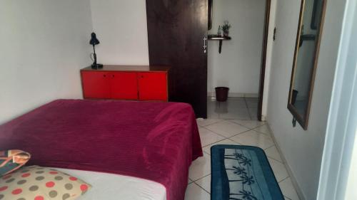 南雅拉瓜Casa do Roberto的一间小卧室,配有一张床和一个红色梳妆台