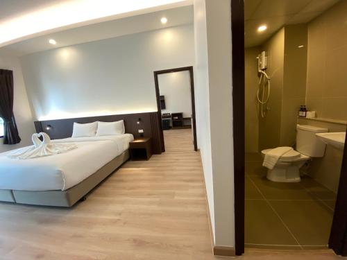 春武里GEEN Hotel Chonburi的一间酒店客房 - 带一张床和一间浴室