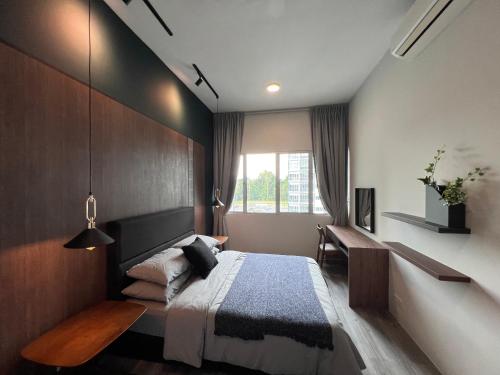 古晋Modern Stylish Apartment near Kuching Airport的一间卧室配有一张床、一张书桌和一个窗户。