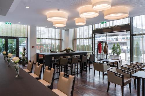 萨尔茨堡欧洲萨尔茨堡奥地利流行酒店的用餐室设有桌椅和窗户。