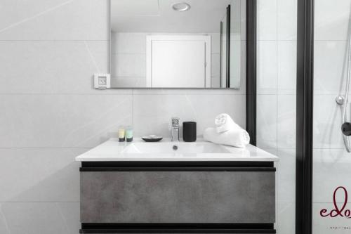 埃拉特דירה למשפחה 50 מטר מהים - By Edom的白色的浴室设有水槽和镜子
