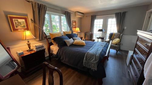 舍布鲁克都卡迷伦住宿加早餐旅馆的一间卧室配有一张带蓝色床单和枕头的床。