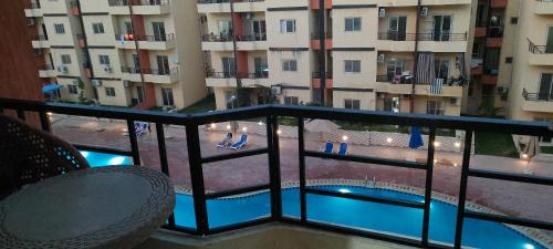 阿莱曼الساحل الشمالي的享有大楼和游泳池景致的阳台