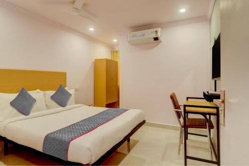 海得拉巴Townhouse Rcc Premier Sr Nagar的一间卧室配有一张床、一张桌子和一张书桌