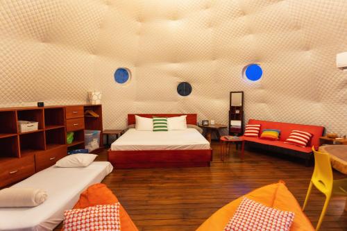 比加瓜Bitzu Dome-Bijagua Riverside Glamping的一间设有两张床和一张沙发的房间