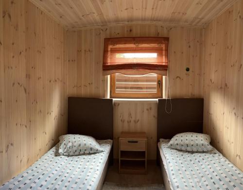 KurėnaiAtostogų namelis的小型客房 - 带2张床和窗户