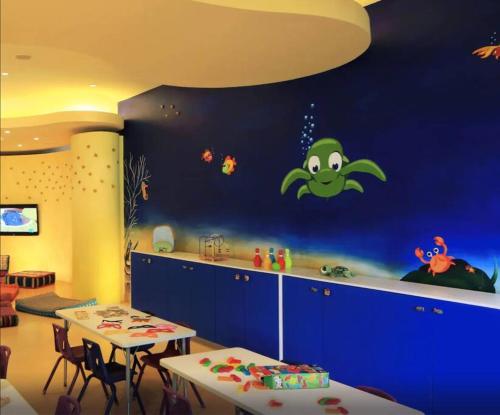 巴亚尔塔港Departamento Frente a la Playa, Velas Vallarta的一间儿童间,设有一张带卡通画的蓝色墙壁