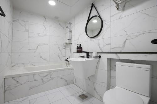 釜山SoL Hotel的白色的浴室设有卫生间和水槽。