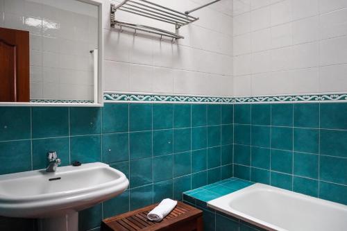 拉拉古纳Cozy Apartment in La Laguna的蓝色和白色的浴室设有水槽和浴缸。