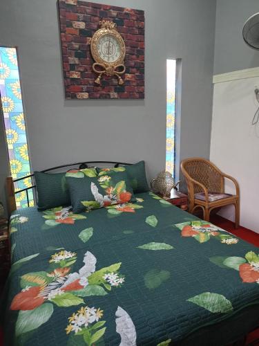 小笨珍Homestay ALHAQIM的一间卧室配有一张带绿色棉被的床
