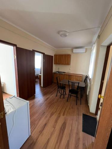 巴尔喀什4-местные домики的客房设有厨房、桌子和椅子。