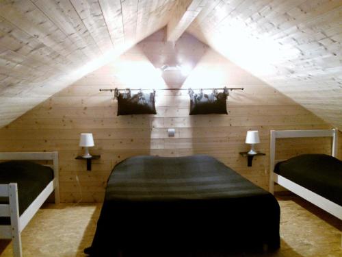 Neychalet de charme le contemporain的阁楼间设有两张床和带灯的天花板