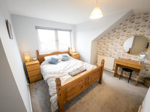 福尔柯克Tranquil 2Bed/2Bath Duplex Falkirk的一间卧室配有一张床、一张书桌和一面镜子