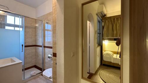 波尔蒂芒Hostel da Praia的带淋浴、卫生间和盥洗盆的浴室