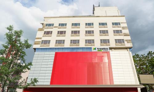 马杜赖Treebo Trend D Grand的红色外墙的高大的白色建筑