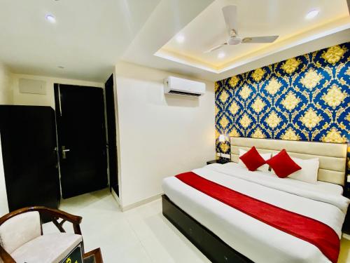 钱德加尔Blueberry Hotel zirakpur-A Family hotel with spacious and hygenic rooms的配有红色枕头的床的酒店客房