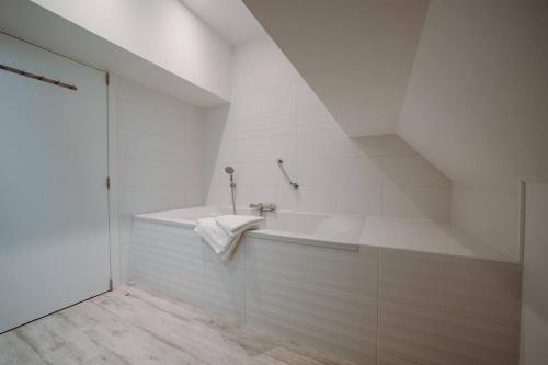 希迈Chimay : La Grande Réserve的白色的浴室设有浴缸和水槽。