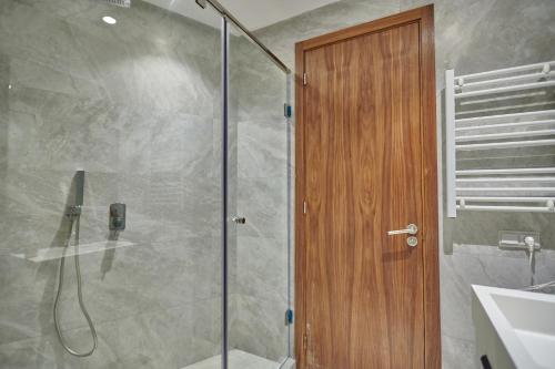 卡萨布兰卡Apartment Sea View B29 -Mosquée Hassan II- By TheCasaEdition的浴室里设有玻璃门淋浴