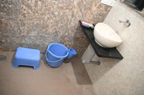 JālgaonHOTEL PRITAM PARK的浴室设有水槽和蓝色垃圾桶