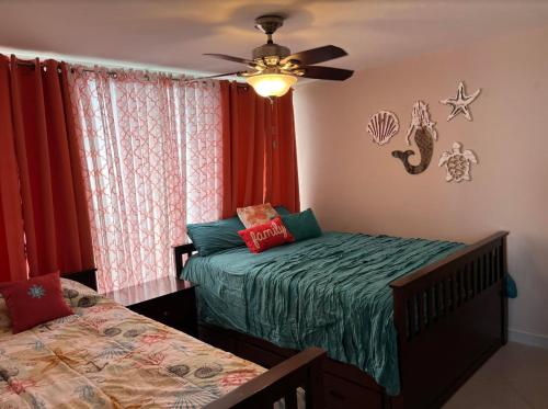 自由港市The Lookout at Coral Beach的一间卧室配有两张床和吊扇