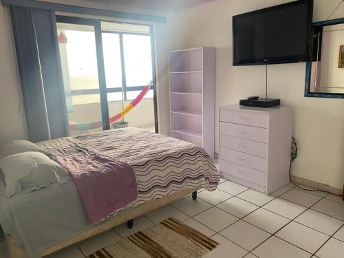 波拉马尔Apartamento Vista al Mar的一间卧室配有一张床和一个带平面电视的梳妆台。